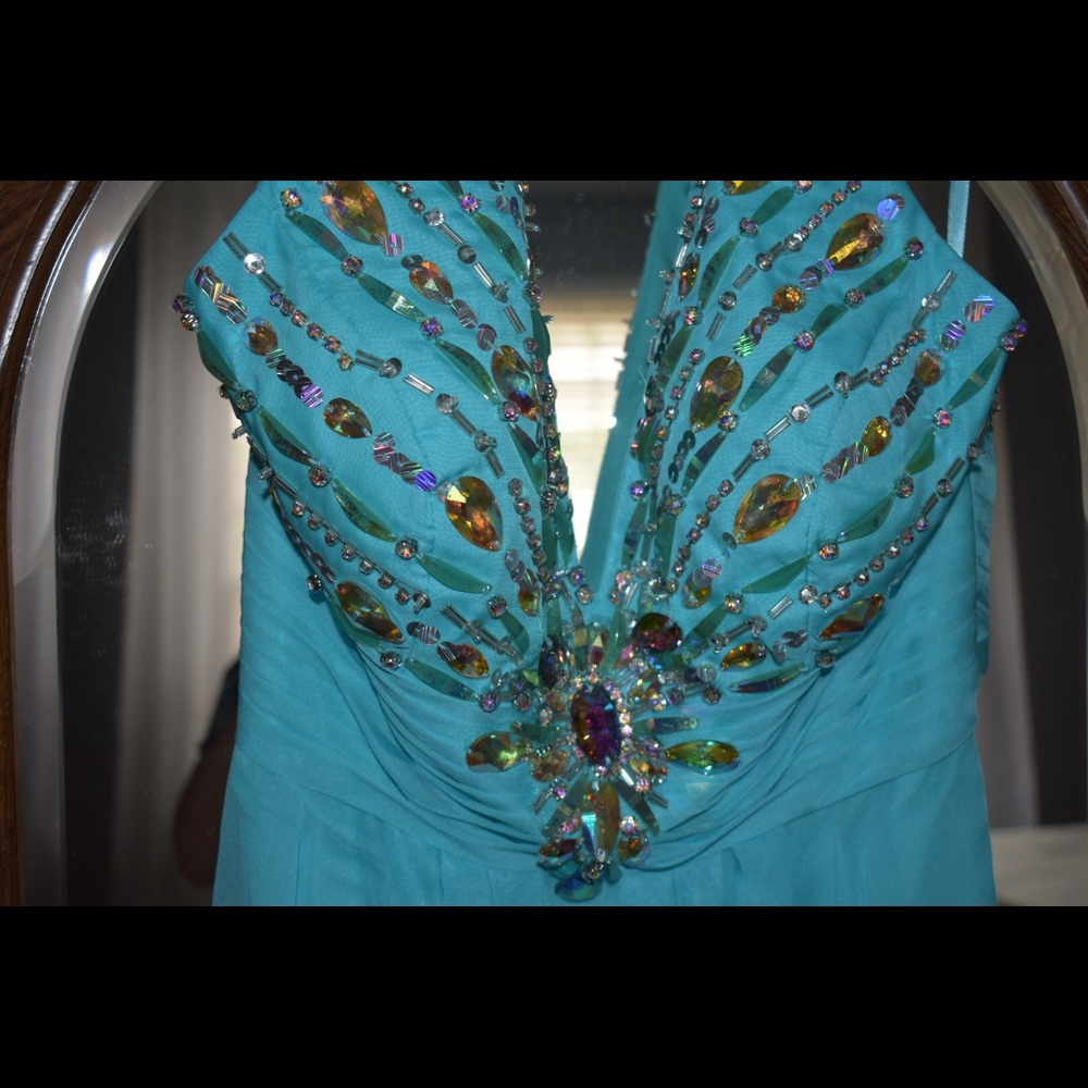 Blue jeweled open back prom dress.
